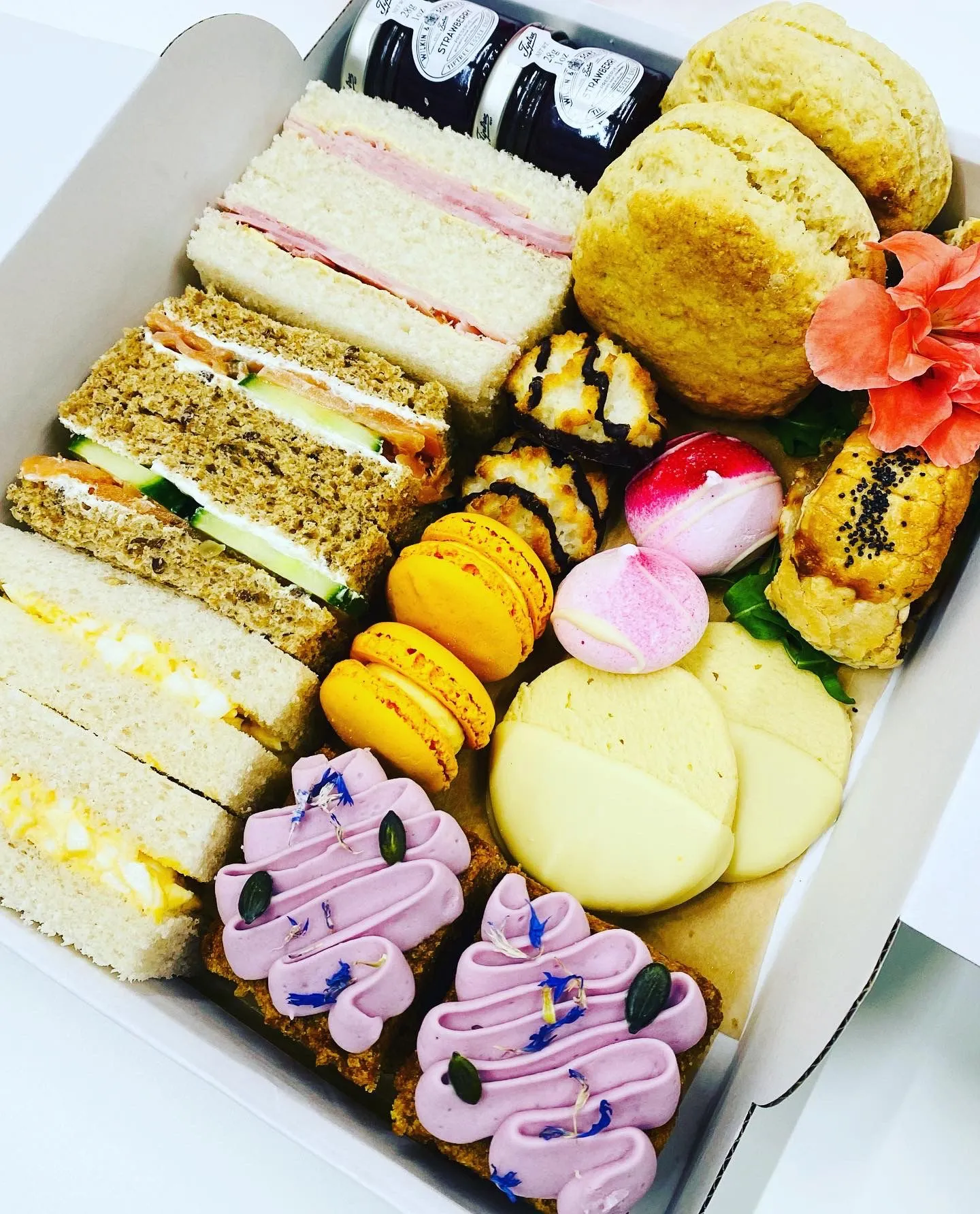 Afternoon tea with sandwiches, cakes, scones, jam & cream