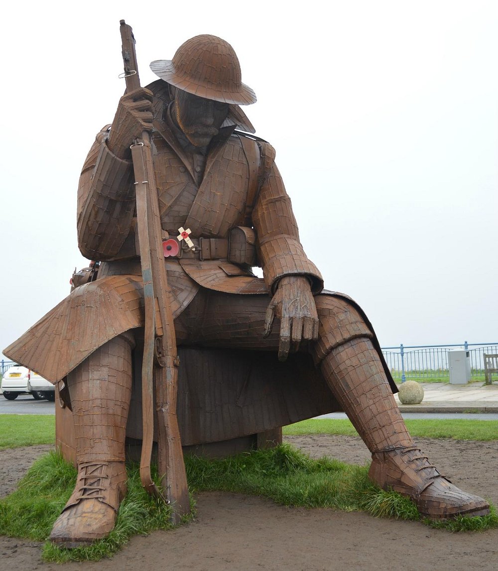 A closer view of Tommy's steel uniform, rifle and downcast face